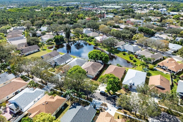 drone / aerial view with a water view and a residential view