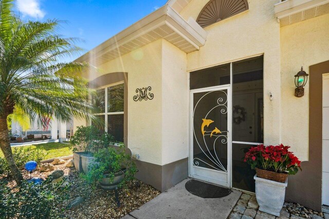 entrance to property with stucco siding