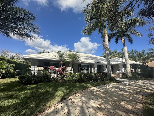 ranch-style house with a front lawn