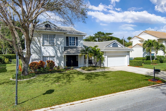 view of front of property with a garage and a front yard