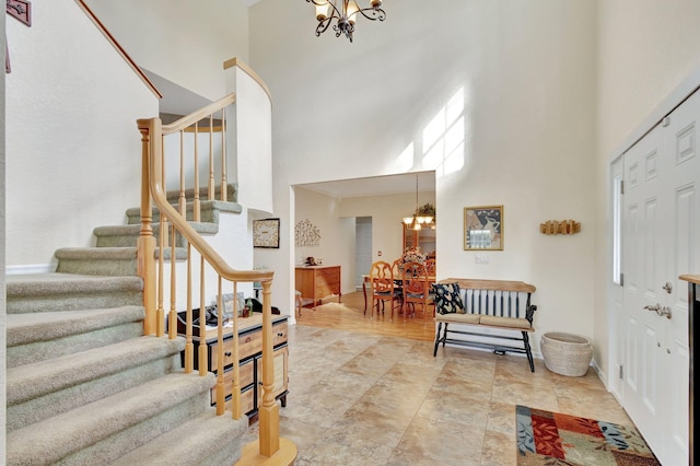 foyer featuring a towering ceiling and a notable chandelier