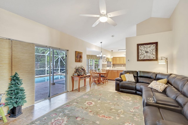 tiled living room with vaulted ceiling and ceiling fan with notable chandelier