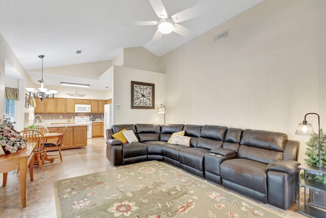 tiled living room featuring lofted ceiling and ceiling fan with notable chandelier