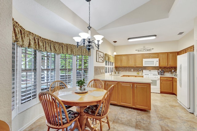 dining room with lofted ceiling, sink, a wealth of natural light, and a notable chandelier