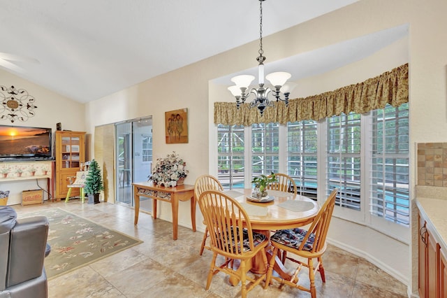 dining room featuring lofted ceiling and a notable chandelier