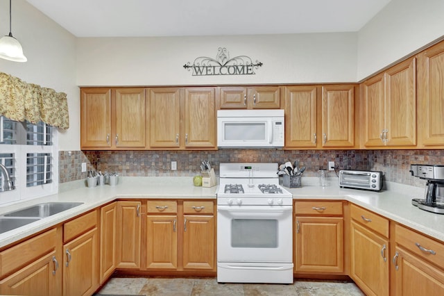 kitchen featuring tasteful backsplash, hanging light fixtures, white appliances, and sink