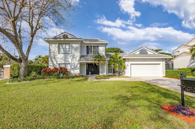 view of front of property with a garage and a front lawn