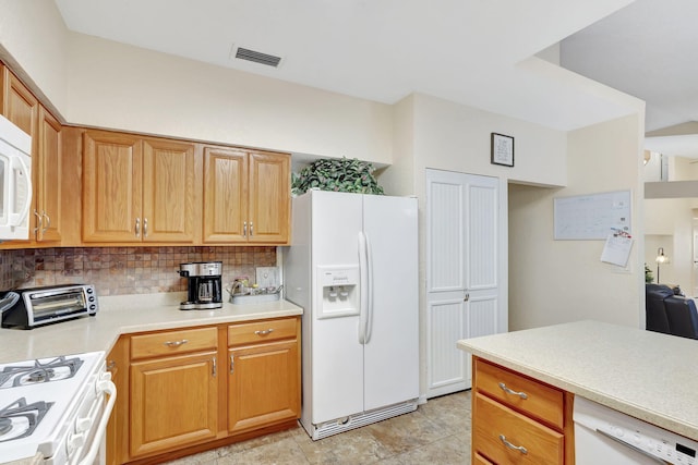 kitchen featuring tasteful backsplash and white appliances