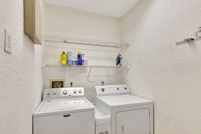 washroom with washing machine and clothes dryer