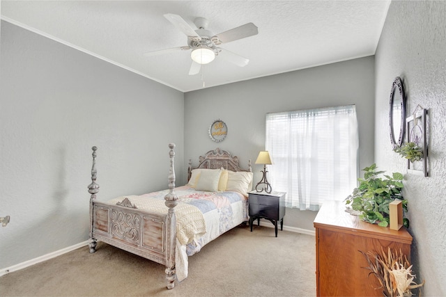 carpeted bedroom featuring ceiling fan and a textured ceiling