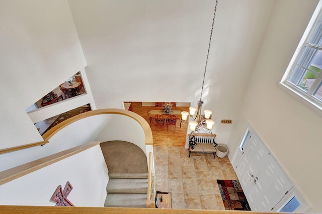 interior space with a chandelier and a high ceiling