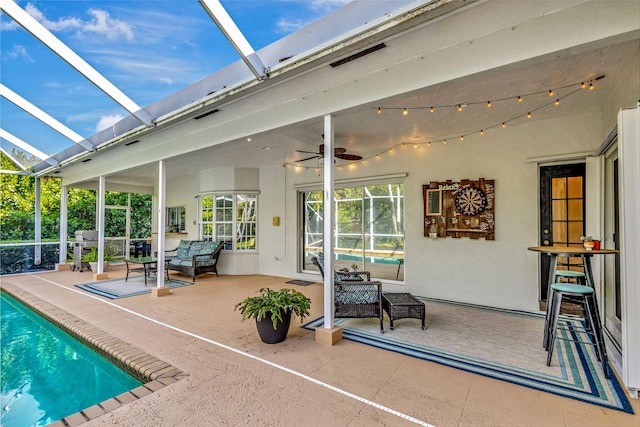 view of pool featuring an outdoor hangout area, a patio, ceiling fan, and glass enclosure