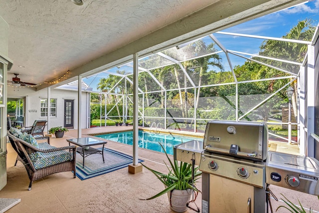 view of swimming pool with grilling area, a patio, and glass enclosure