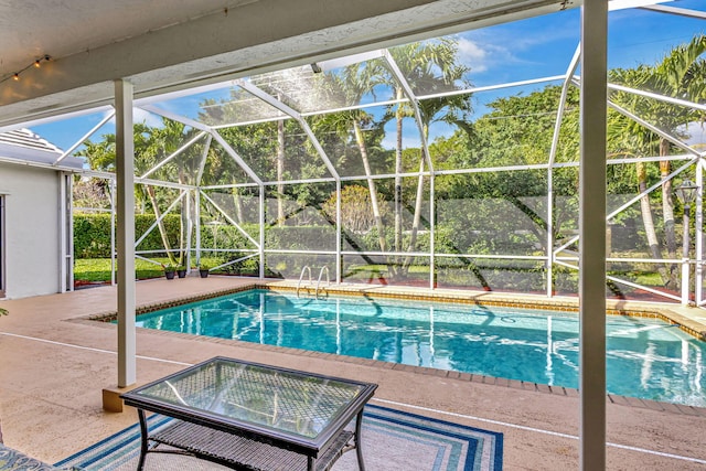 view of swimming pool featuring a lanai and a patio