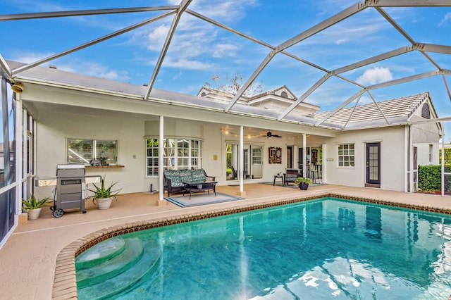 back of house featuring ceiling fan, a patio, and glass enclosure