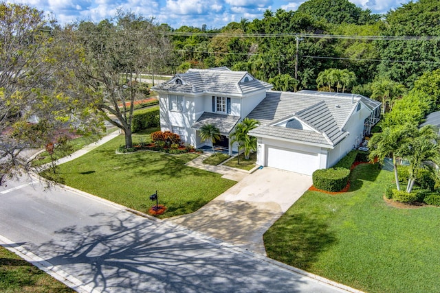 view of front of house with a garage and a front lawn