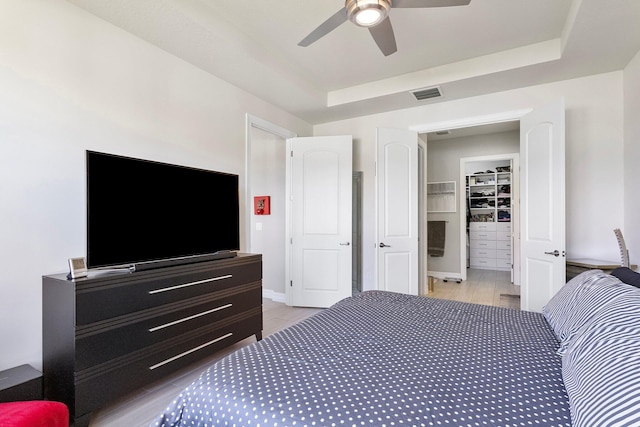 bedroom featuring ceiling fan and a tray ceiling