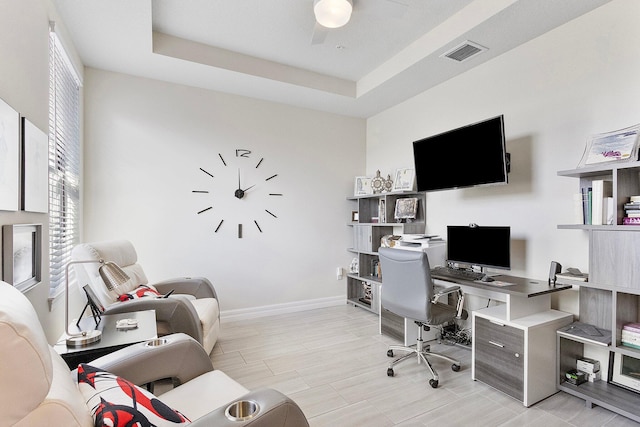 office with ceiling fan and a tray ceiling