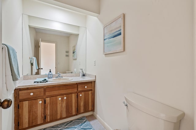 bathroom with tile patterned floors, vanity, and toilet