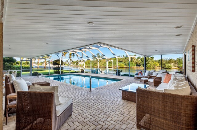 view of swimming pool with an outdoor living space, a patio, and glass enclosure