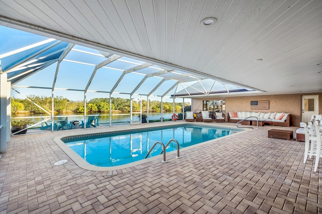 view of swimming pool with a water view, an outdoor living space, a patio area, and glass enclosure