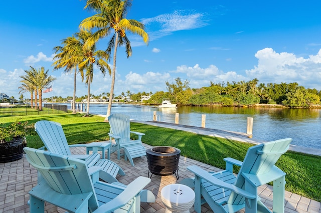 view of patio featuring a water view and an outdoor fire pit