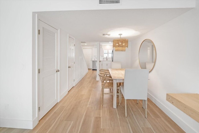 1300 Seaway Dr Unit B6, Fort Pierce, FL 34949 - dining space with an inviting chandelier and light hardwood / wood-style floors