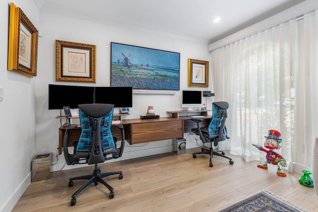 office space featuring ornamental molding and light wood-type flooring