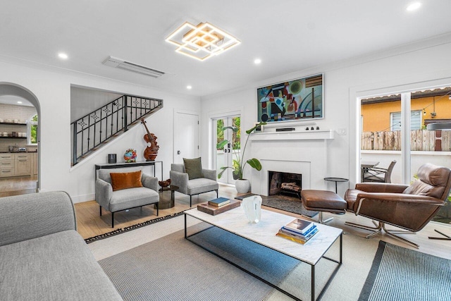 living room featuring hardwood / wood-style flooring and crown molding