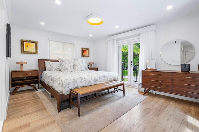 bedroom featuring crown molding, light hardwood / wood-style flooring, and access to outside