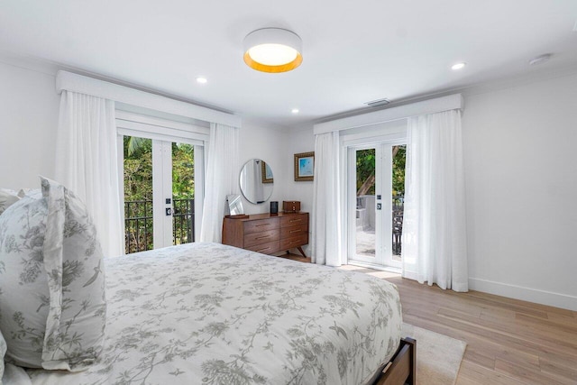 bedroom with multiple windows, access to exterior, and french doors