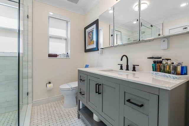 bathroom with crown molding, vanity, toilet, and a shower with door