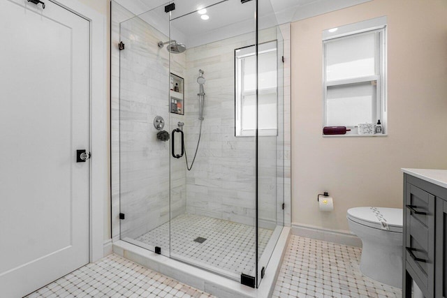 bathroom featuring vanity, toilet, tile patterned flooring, and a shower with door