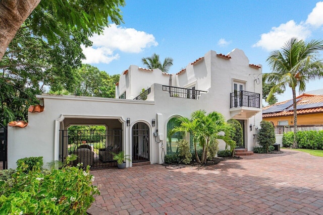 mediterranean / spanish house featuring a balcony