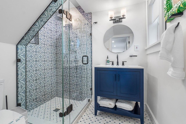 bathroom featuring vanity and a shower with shower door