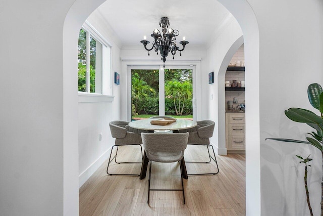 dining area featuring a notable chandelier and light wood-type flooring