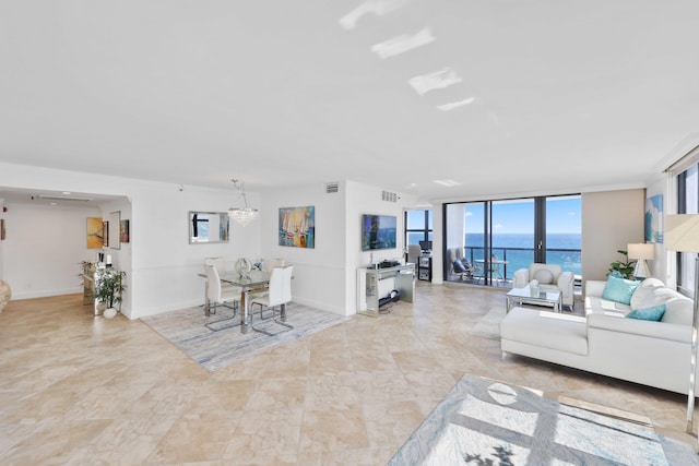 living room with expansive windows and a chandelier