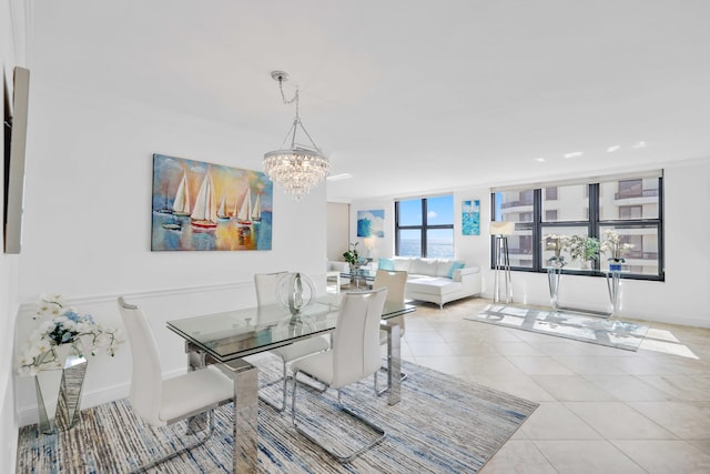 tiled dining room featuring a chandelier