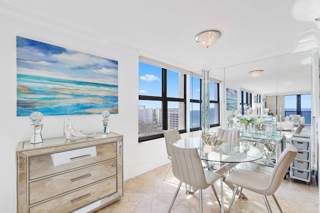 tiled dining area featuring a water view, ornamental molding, plenty of natural light, and expansive windows