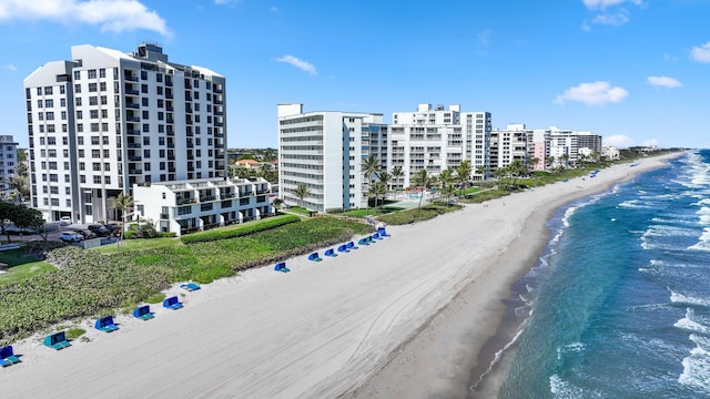 birds eye view of property featuring a water view and a view of the beach