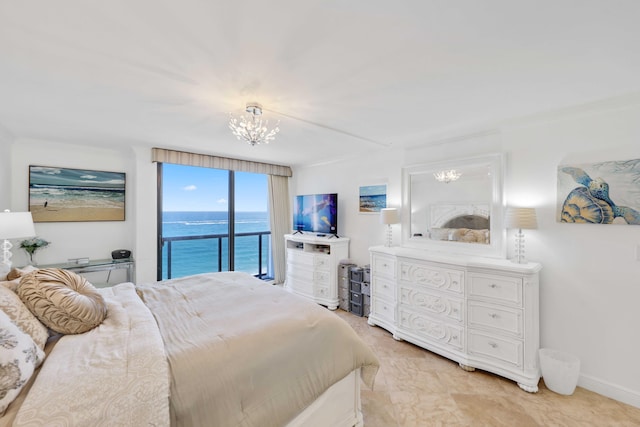 bedroom with access to outside and an inviting chandelier