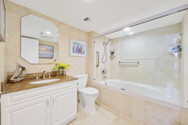 full bathroom with tiled shower / bath, vanity, and toilet