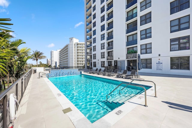 view of pool with pool water feature and a patio area