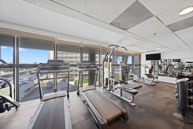 gym with a paneled ceiling