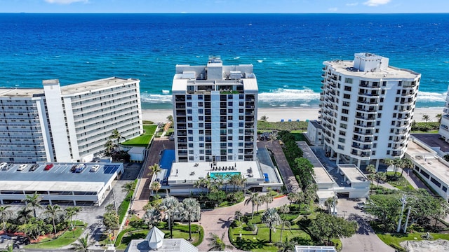 bird's eye view with a water view and a beach view