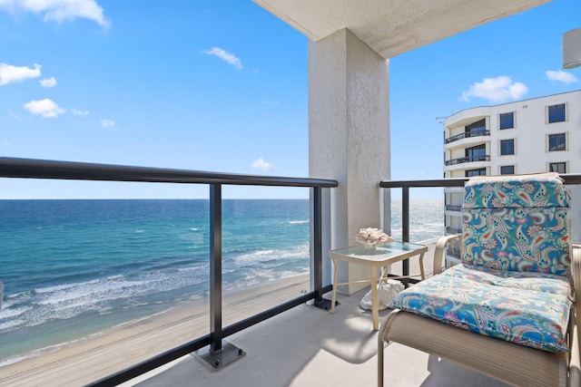 balcony with a water view and a beach view