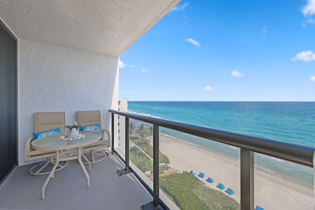 balcony with a beach view and a water view