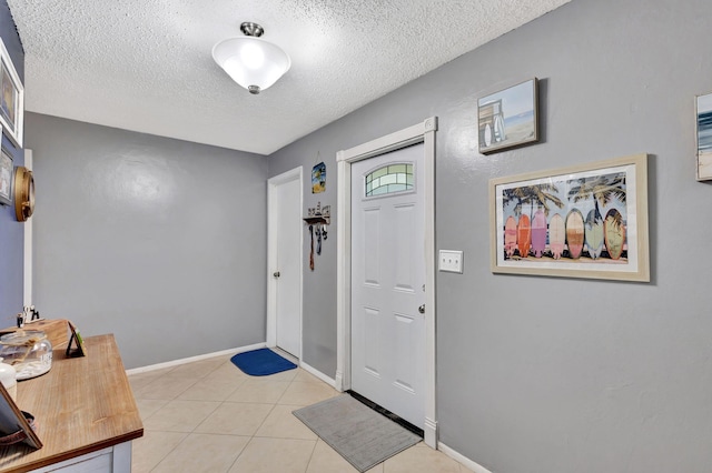 tiled foyer featuring a textured ceiling