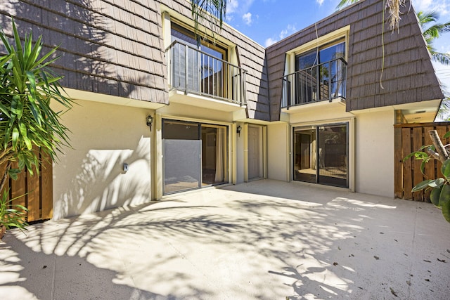 rear view of house with a balcony and a patio area