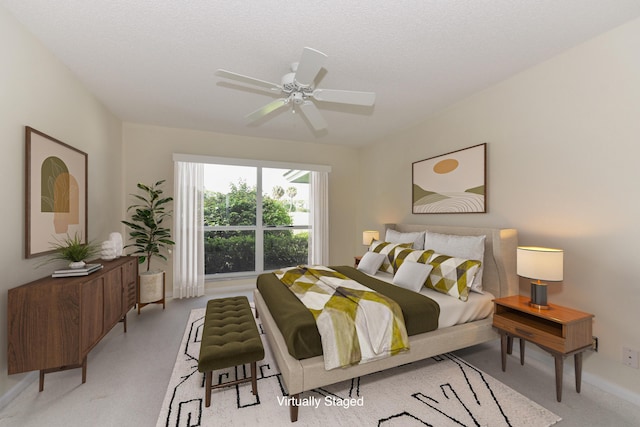 bedroom with ceiling fan and a textured ceiling